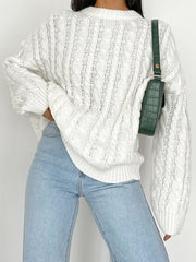 White cable knit openwork sweater with crew neck and long sleeves.