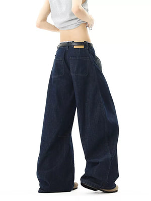 Oversized dark-wash cotton men's jeans with wide legs and back pockets.