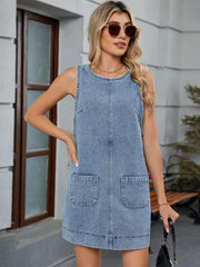 Light blue denim sleeveless pinafore dress with patch pockets and back detail.