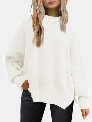 White ribbed knit sweater with slouchy sleeves and mock neck.