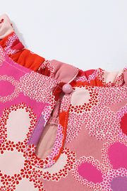 Floral embroidered yoke ruffle sleeve top in strawberry pink with a keyhole neckline and button closure.