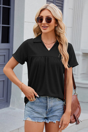 Black polo top with short sleeves and gathered yoke detail