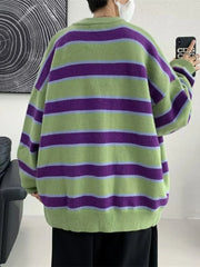 Oversized green striped V-neck cardigan with purple and light blue stripes.