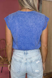 Blue mineral wash cotton tee with distressed details and lace cap sleeves.