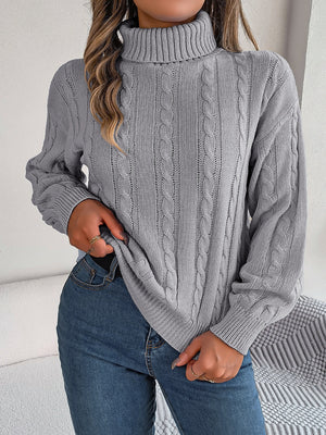 Dark Gray cable knit turtleneck sweater with voluminous sleeves and ribbed cuffs.