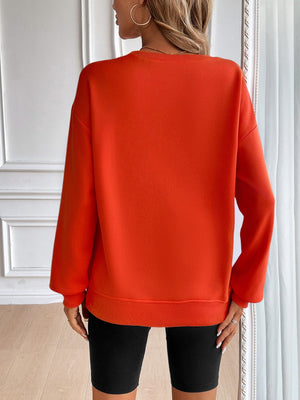 Orange relaxed fit sweatshirt with crewneck and long sleeves.