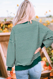Dark green and white striped sweatshirt with lettuce hem detail.