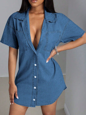 Oversized denim shirt dress in medium wash with a deep plunge neckline, collared, short sleeves, and button front.