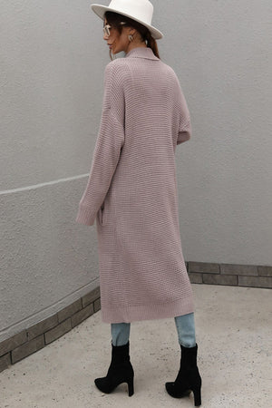 Textured knit maxi cardigan in a soft pink hue with pockets and a relaxed fit.