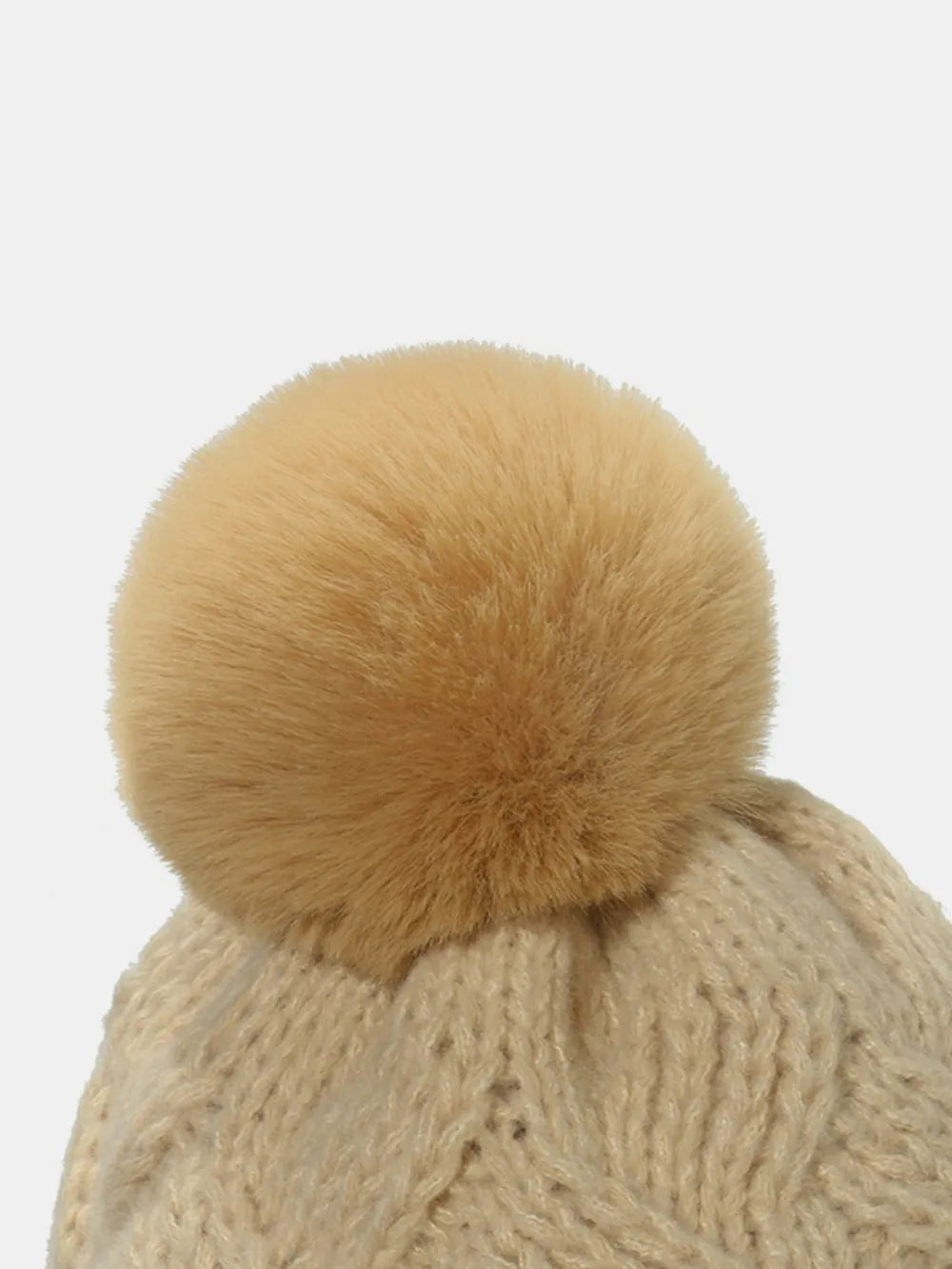 Beanie with cable knit pattern and fluffy pom in Dust Storm acrylic.