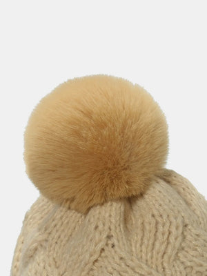 Beanie with cable knit pattern and fluffy pom in Dust Storm acrylic.