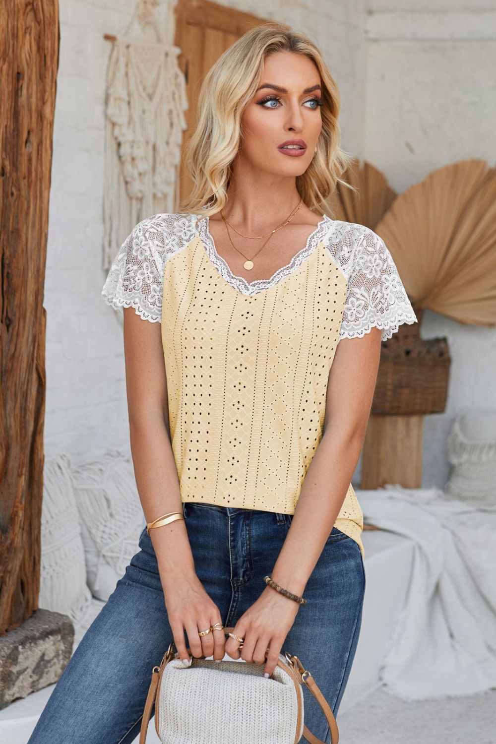 Light yellow eyelet blouse with white lace short sleeves and V-neck.