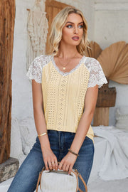 Light yellow eyelet blouse with white lace short sleeves and V-neck.