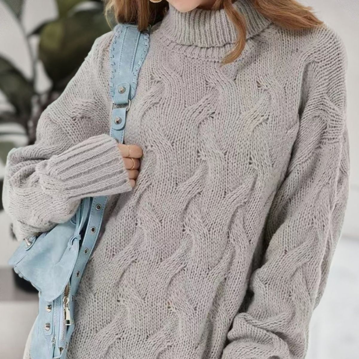 Gray cable knit turtleneck mini dress with textured pattern and ribbed cuffs.