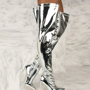 Silver thigh-high stiletto boots with side zippers and a shiny metallic finish.