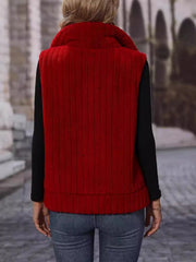 Plush corduroy zip-up gilet in rust with a stand-up collar and vertical ribbed texture.