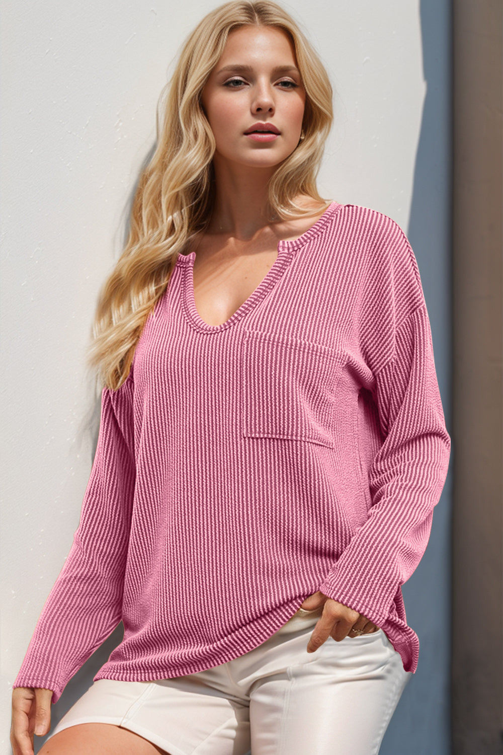 Pink ribbed plunge neck top with chest pocket and long sleeves.
