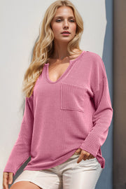 Pink ribbed plunge neck top with chest pocket and long sleeves.