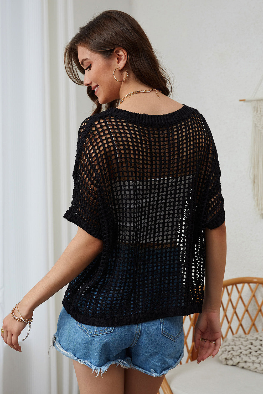 Black open-knit slouchy shoulder cover-up with short sleeves and a relaxed fit.