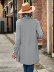 Draped cascade cardigan in gray with long sleeves and an open front, styled with a hat.