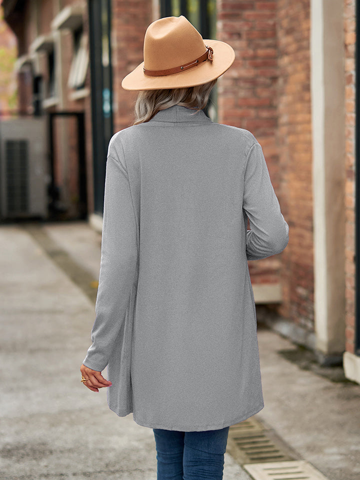 Draped cascade cardigan in gray with long sleeves and an open front, styled with a hat.