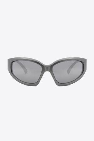 Sculpted Shield sunglasses in mid gray with dark lenses and a bold, angular frame.
