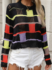 Patchwork openwork sweater in black with colorful blocks and open knit details.