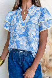 Tropical floral v-neck frill blouse with yellow trim and short sleeves.