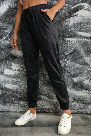 Black Shadow Leopard Relaxed-Fit Drawstring Trousers with pockets and cuffed ankles.