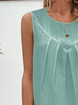 Sleeveless light blue top with a textured fabric and pleated front detail.