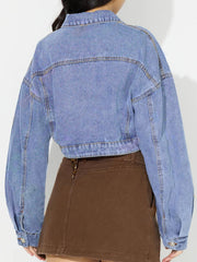Cropped denim jacket in medium wash with balloon sleeves and buttoned cuffs.
