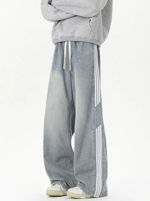 Relaxed fit wide-leg jeans in Vintage Blue with white side stripes and drawstring waist.