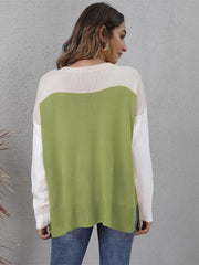 Colorblock crewneck knit sweater in lime green, cream, and white with side slits.