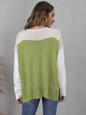 Colorblock crewneck knit sweater in lime green, cream, and white with side slits.
