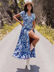 Blue floral v-neck midi dress with short sleeves, button front, and high slit.