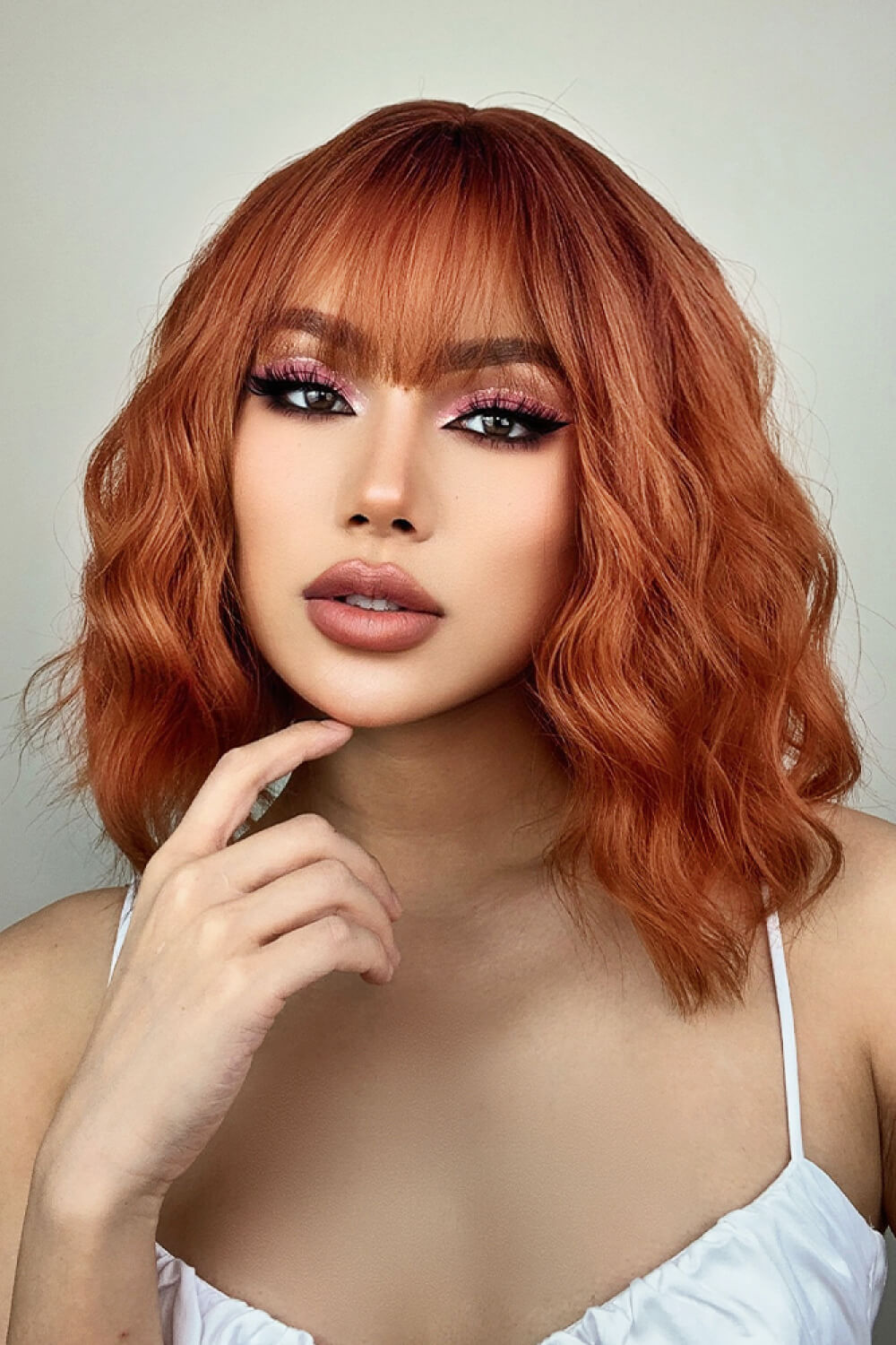 Rose Quartz bob wig with bangs in ochre, wavy style
