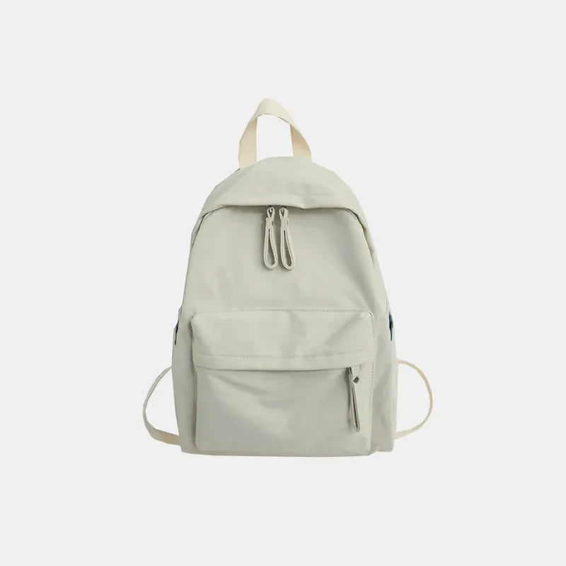 Ivory canvas school backpack with dual front pockets and zipper closure.