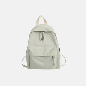 Ivory canvas school backpack with dual front pockets and zipper closure.
