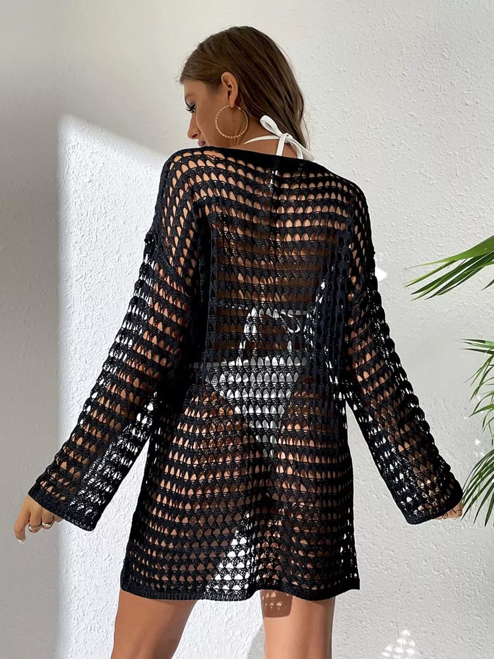 Black sheer crochet knit cover-up with openwork pattern and long sleeves.