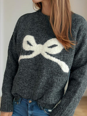 Dark gray acrylic knit sweater with a white intarsia bow design.