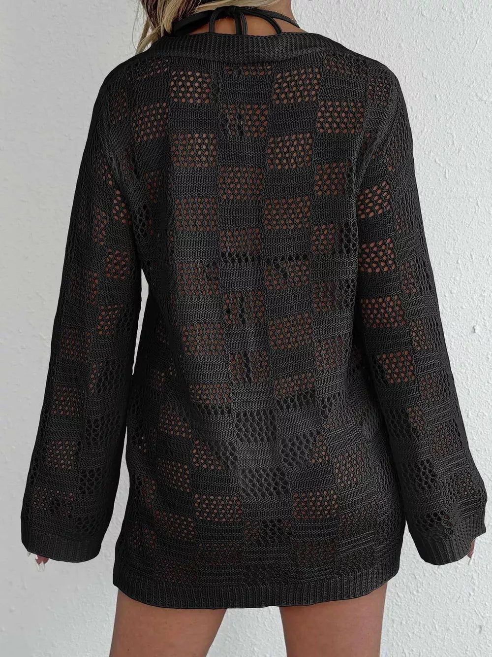 Black openwork crochet cover-up with long sleeves and a tie-front detail.