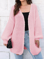 Blush pink balloon sleeve cardigan with pearl buttons and open front.