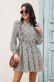 Cream dot print dress with ruffle trim, high neckline, long sleeves, and tiered skirt.