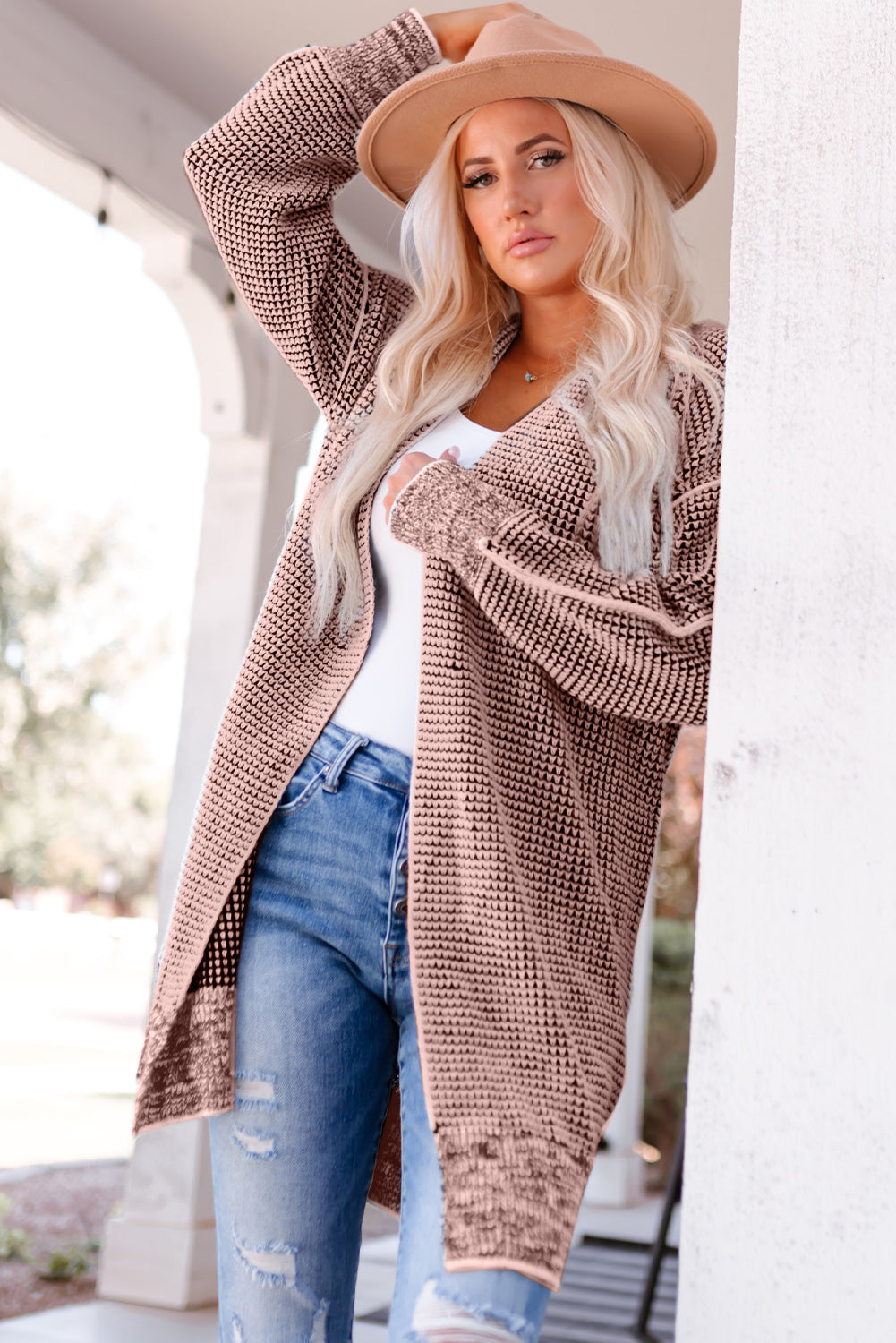 Textured puff sleeve open cardigan in pink with a waffle knit pattern and open front.