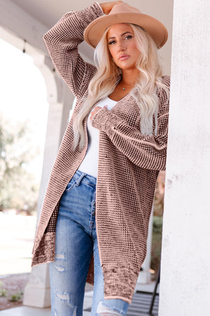 Textured puff sleeve open cardigan in pink with a waffle knit pattern and open front.