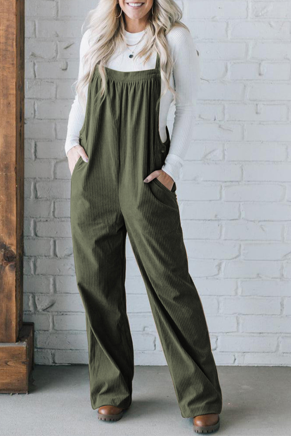 Army green corduroy wide-leg overalls with front pockets and button details.