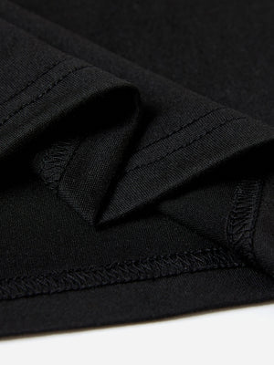 Black t-shirt detail showing textured fabric and double-stitched seams.