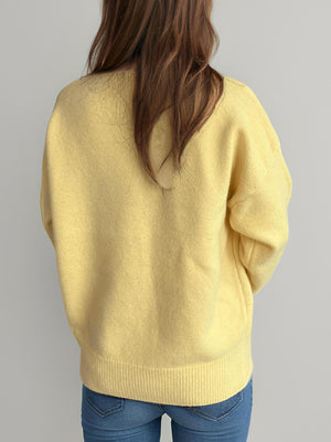 Yellow oversized crewneck knit pullover sweater with ribbed hem and cuffs.