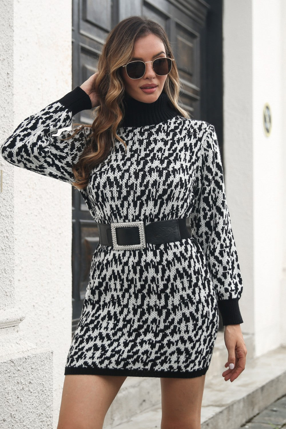 Houndstooth knit turtleneck mini dress in black and white with long sleeves.