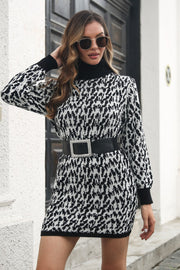 Houndstooth knit turtleneck mini dress in black and white with long sleeves.